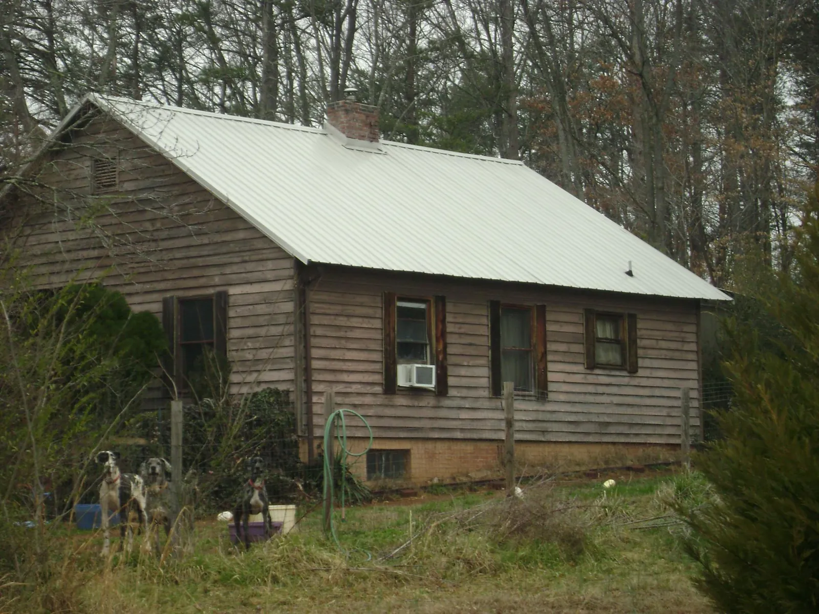 White metal roof on an old wood sided farmhouse, from a Metal Roof Installation job in Autaugaville